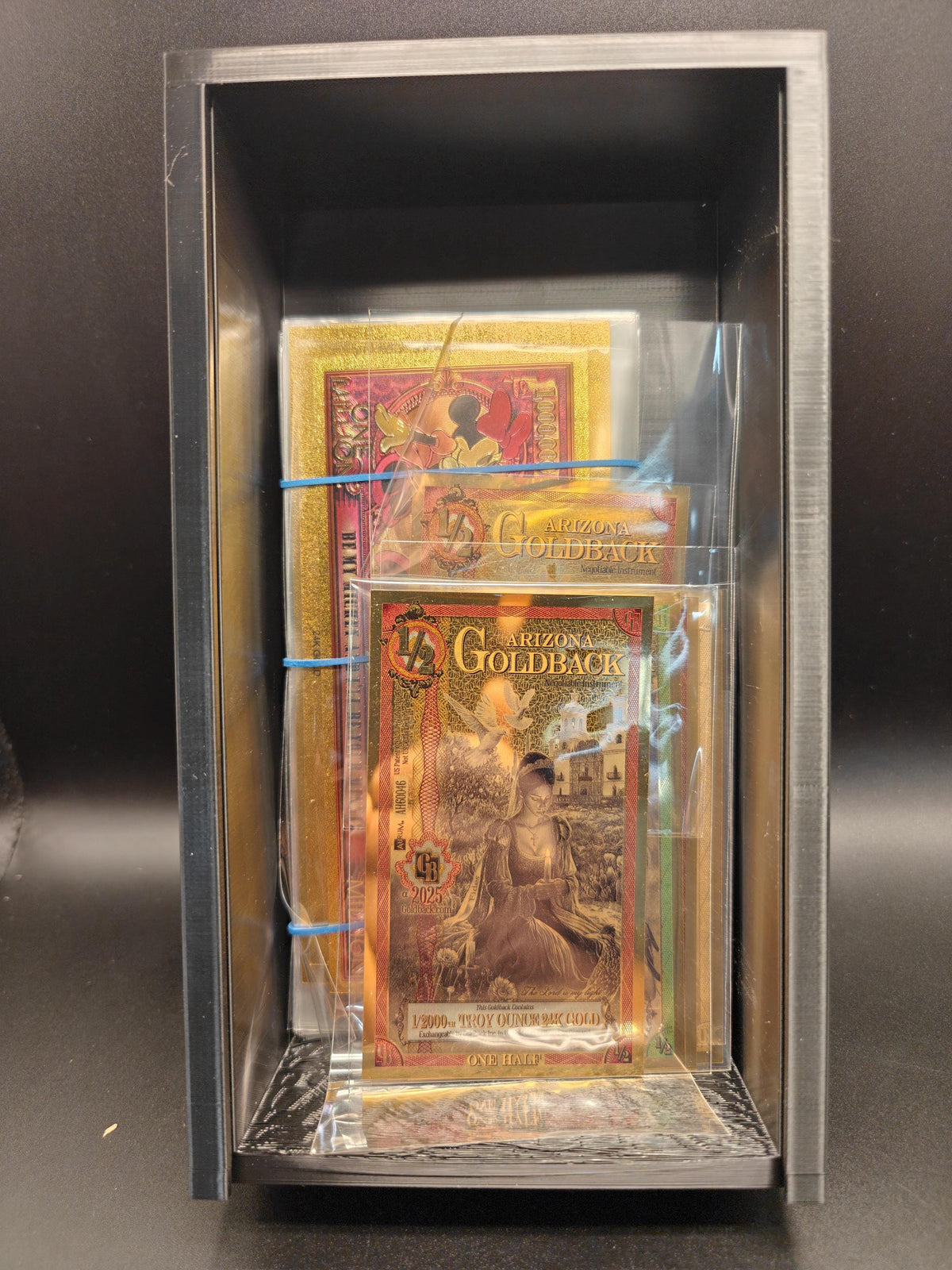 Goldbacks and money box